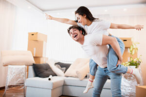 happy husband wife have fun swirl sway relocating own apartment together relocation concept overjoyed young couple dance living room near cardboard boxes entertain moving day