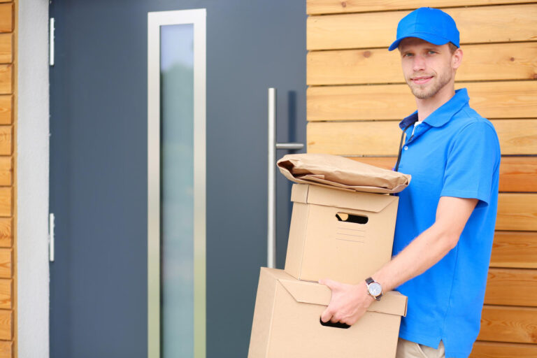 smiling delivery man blue uniform delivering parcel box recipient courier service concept smiling delivery man blue uniform
